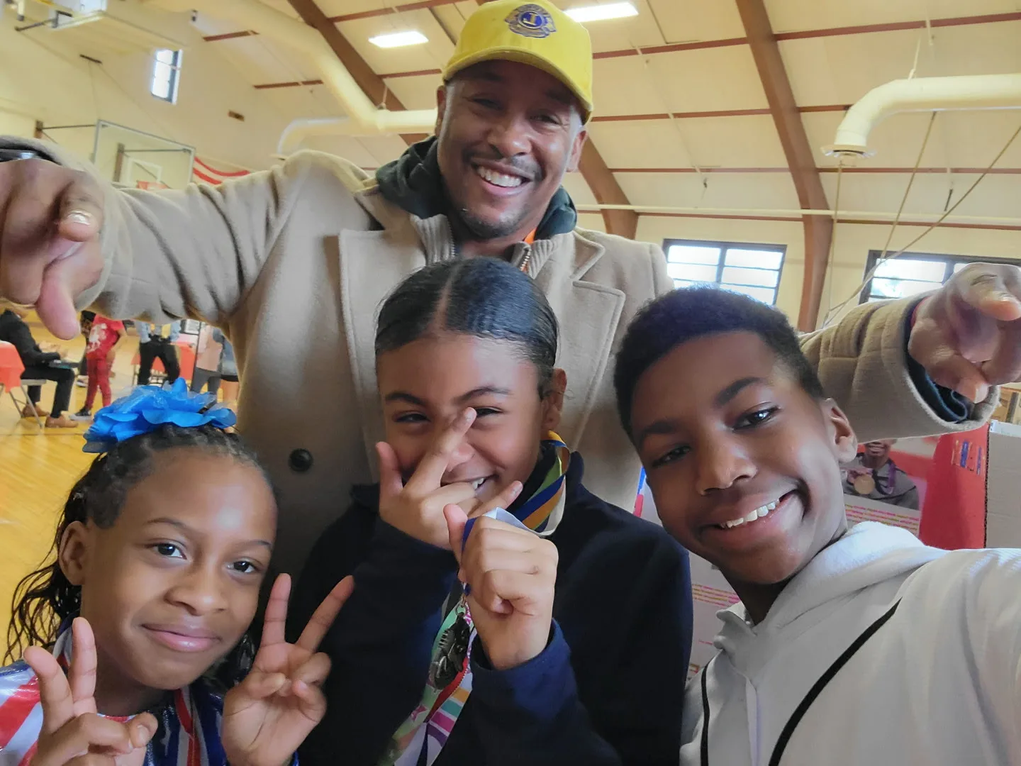 Michael McCline with three young people at a community event